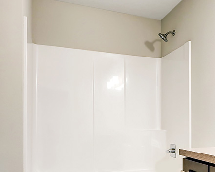 A Brand New Waterproof White Shower Liner Panel With a Soap Holder