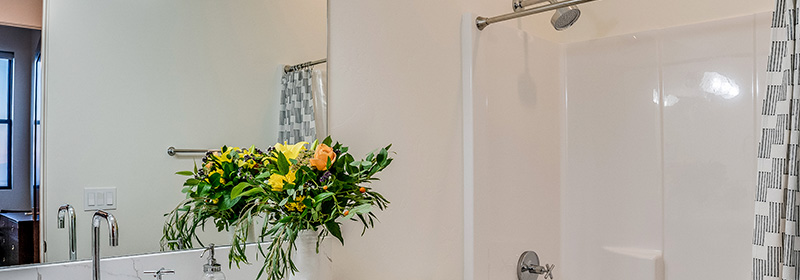 Beautiful Bathroom With Flowers and New Shower Liner Panels After Tub-to-Shower Conversion